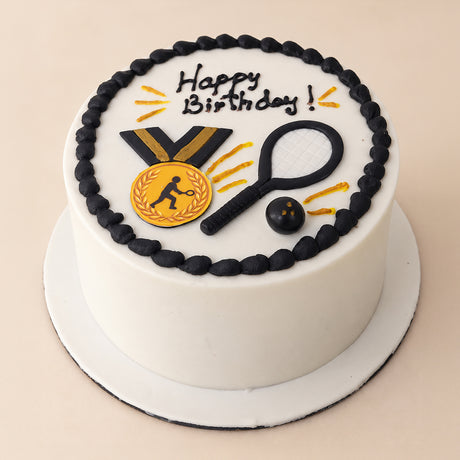 Black and White Tennis Medal Cake: white buttercream with black border, fondant gold medal, racket and ball